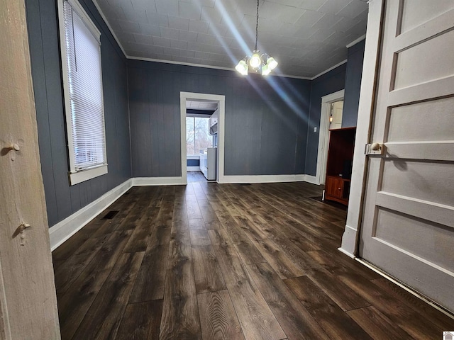 additional living space with dark wood-style floors, a chandelier, visible vents, and baseboards