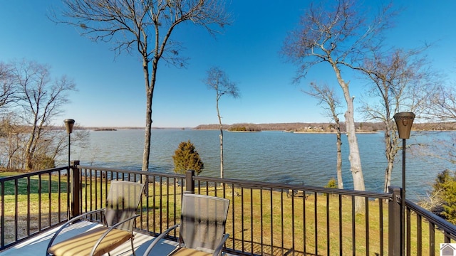 wooden deck with a water view and a yard