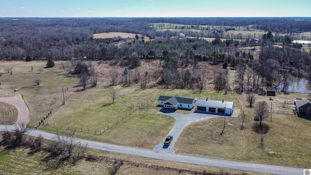 birds eye view of property featuring a rural view and a view of trees