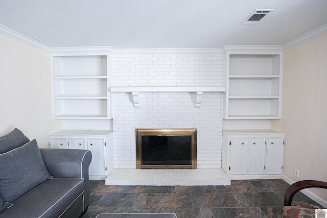 living room with built in features, crown molding, a fireplace, visible vents, and stone finish flooring