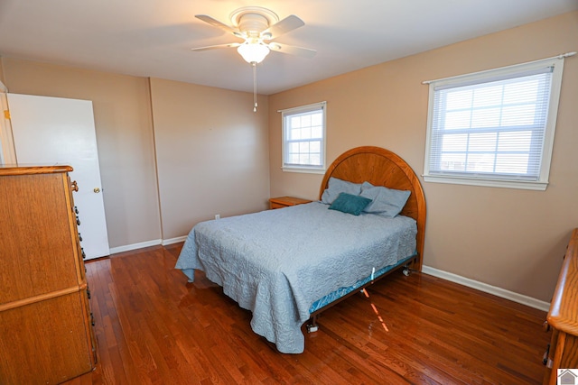 bedroom with a ceiling fan, baseboards, and wood finished floors