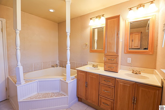 bathroom featuring tile patterned flooring, double vanity, a sink, and a bath