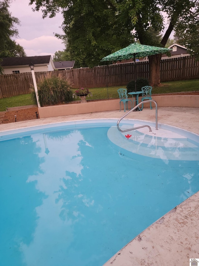 view of swimming pool featuring a patio and a fenced backyard