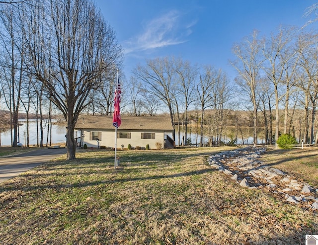 view of front facade with a water view and a front yard