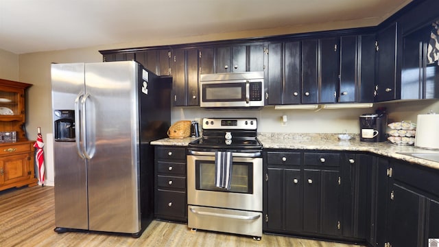 kitchen with stainless steel appliances and light wood-style flooring