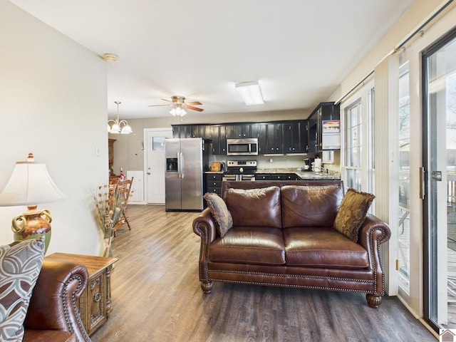 living room featuring ceiling fan and wood finished floors