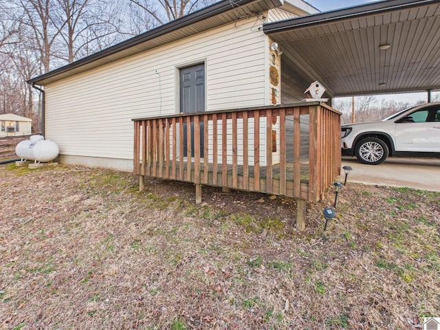 view of side of property with a deck and an attached carport