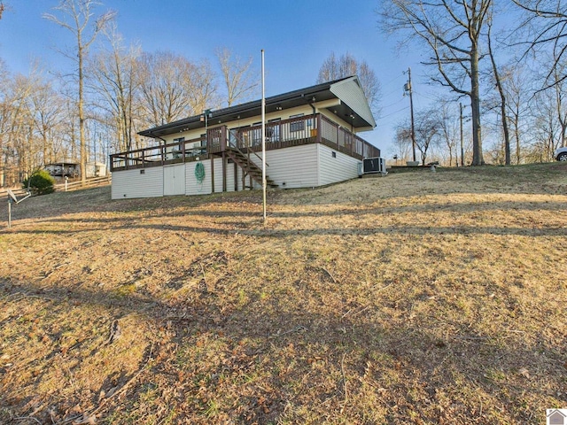 back of property with a lawn, central AC unit, fence, a wooden deck, and stairs