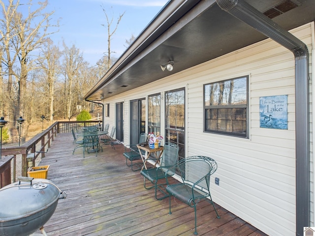 wooden terrace featuring outdoor dining area