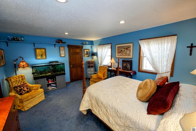 bedroom with carpet floors, a textured ceiling, and recessed lighting