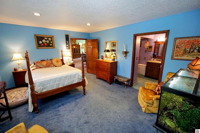 carpeted bedroom featuring a textured ceiling, ensuite bathroom, and recessed lighting