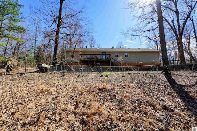 back of house with a deck, fence, and stairs