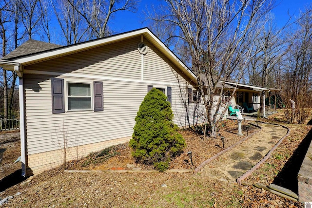 view of property exterior with roof with shingles