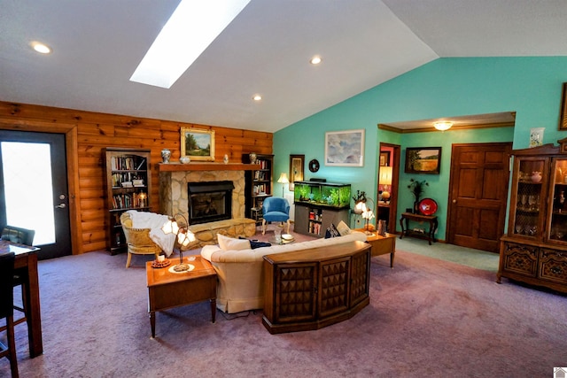 living room featuring vaulted ceiling with skylight, a stone fireplace, carpet floors, and recessed lighting