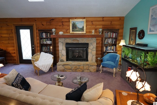 living area with carpet floors, log walls, and a stone fireplace