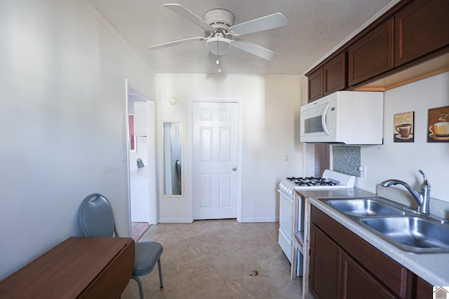 kitchen featuring dark brown cabinetry, white appliances, a ceiling fan, a textured ceiling, and a sink