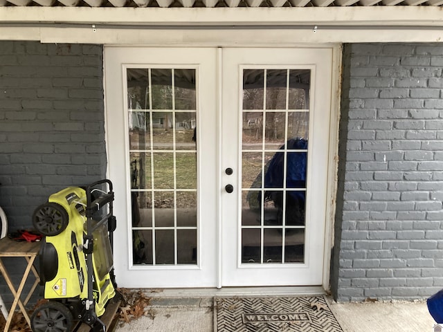 entryway featuring brick wall and french doors