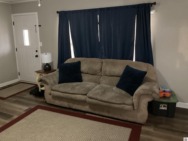 living area with baseboards and wood finished floors