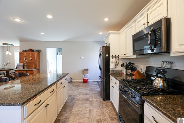 3929 Griggstown Rd, Calvert City, KY 42029 - kitchen with baseboards, appliances with stainless steel finishes, dark stone countertops, and recessed lighting