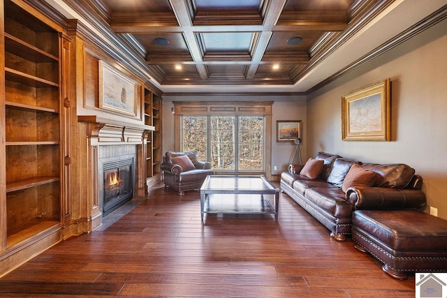 living area with coffered ceiling, a fireplace with flush hearth, dark wood-style floors, beamed ceiling, and crown molding