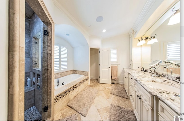 bathroom with a sink, a stall shower, a garden tub, and crown molding