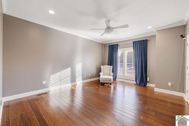 unfurnished room with wood-type flooring, visible vents, a ceiling fan, and ornamental molding