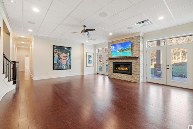 unfurnished living room featuring visible vents, baseboards, wood-type flooring, stairway, and french doors