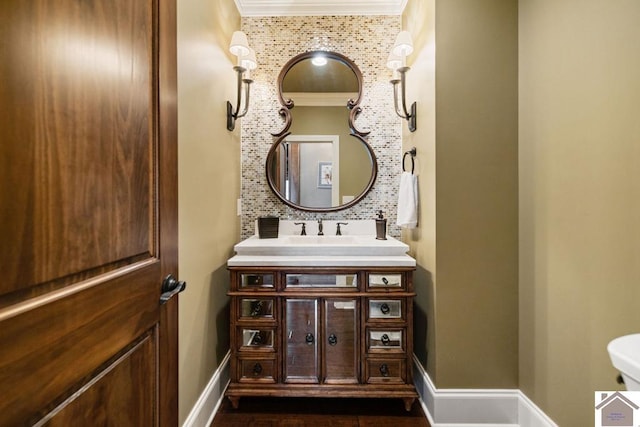 half bathroom featuring baseboards and vanity