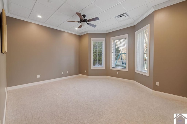 carpeted spare room featuring ornamental molding, visible vents, and baseboards