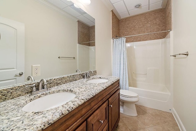 bathroom featuring tile patterned flooring, a sink, toilet, and shower / bath combo