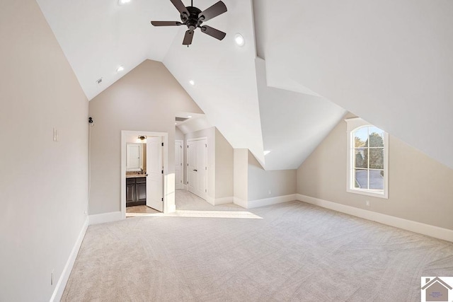 bonus room with light colored carpet, vaulted ceiling, baseboards, and ceiling fan