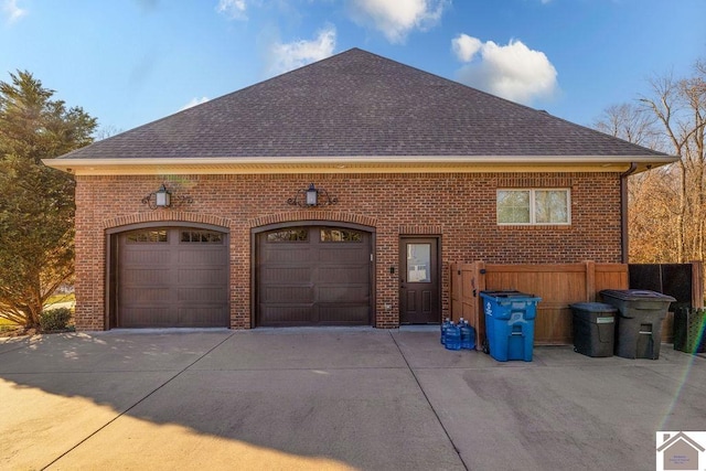 garage featuring concrete driveway