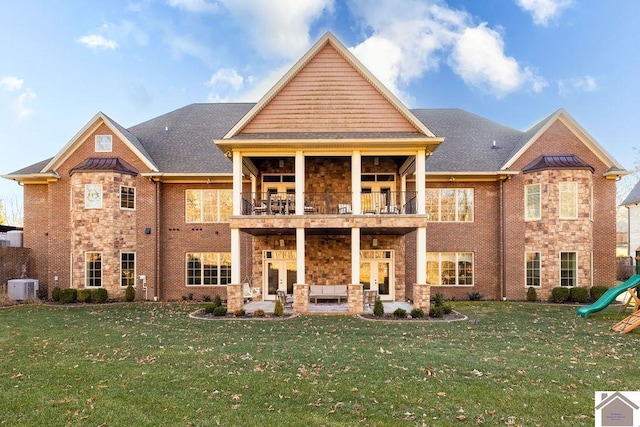 rear view of property featuring french doors, a yard, a patio, a balcony, and cooling unit