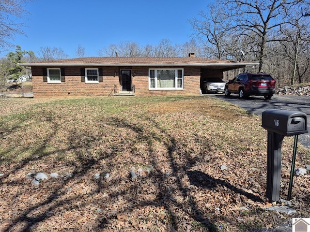 ranch-style house with driveway, a front yard, a carport, and brick siding