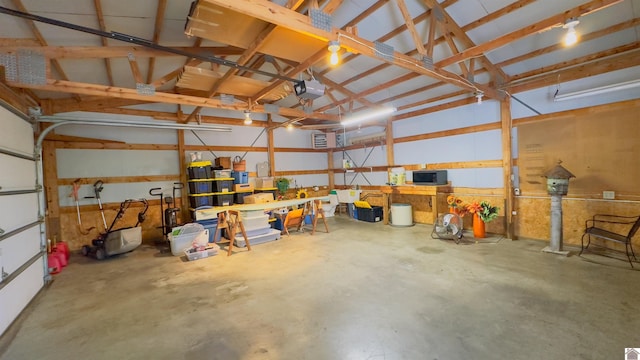 garage with a garage door opener and a workshop area