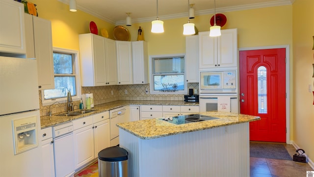 kitchen featuring white appliances, tasteful backsplash, white cabinetry, and a sink