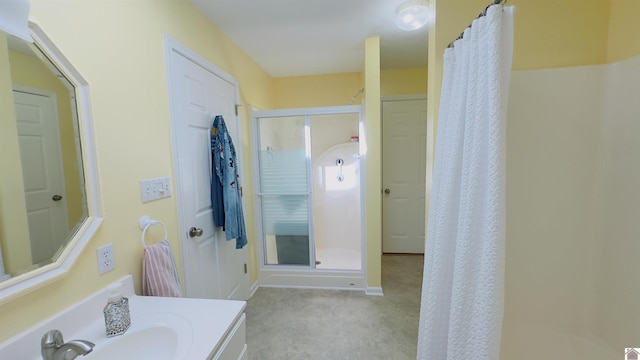 bathroom with a stall shower and vanity