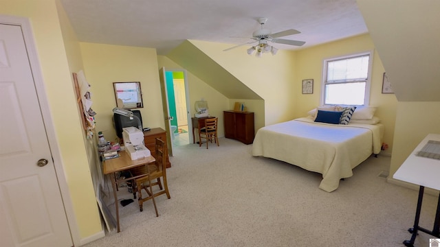 bedroom with ceiling fan, vaulted ceiling, and carpet flooring