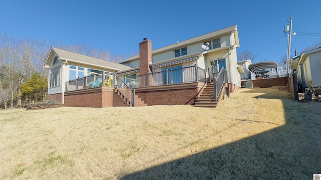 rear view of property with a lawn, a deck, and stairs