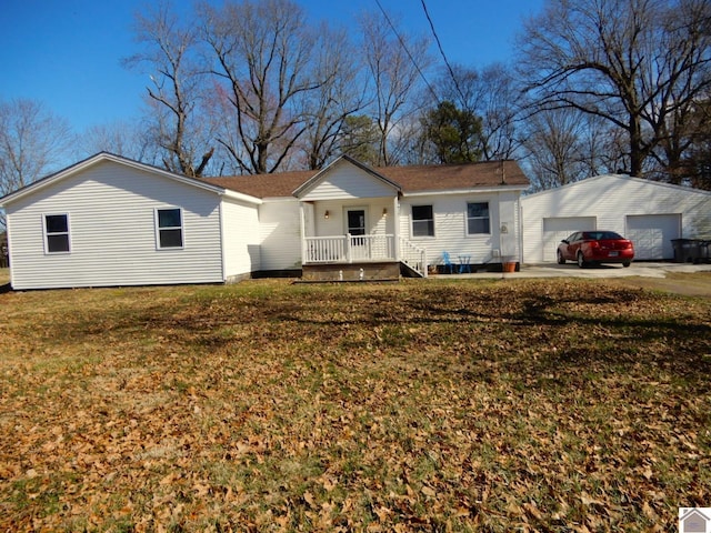 view of front of house featuring a garage, a front lawn, and an outdoor structure