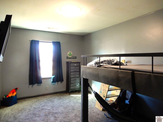 bedroom featuring carpet flooring and baseboards