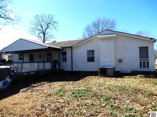 rear view of property featuring cooling unit