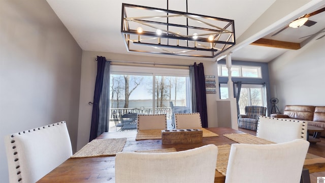 dining room featuring wood finished floors, beam ceiling, and a notable chandelier