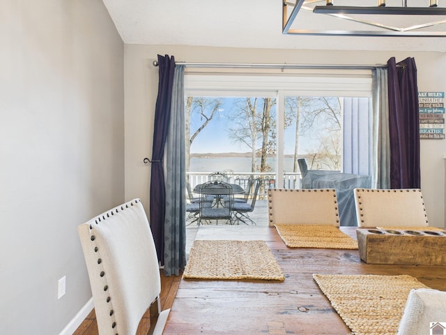 interior space with baseboards and wood finished floors