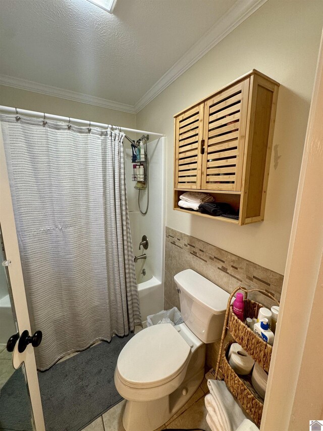 bathroom featuring a wainscoted wall, crown molding, tile walls, shower / bath combination with curtain, and toilet