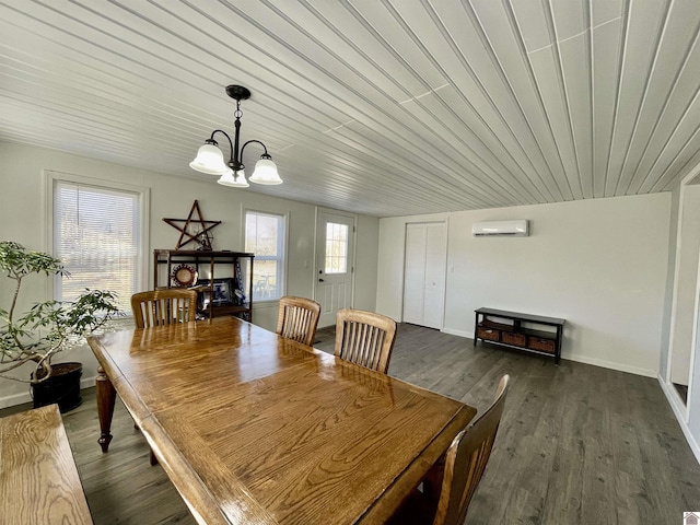 dining area featuring a wall unit AC, an inviting chandelier, baseboards, and dark wood-style flooring