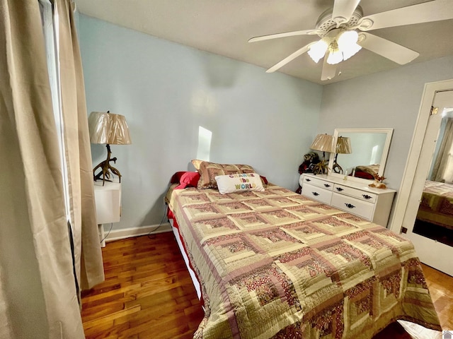 bedroom with ceiling fan, baseboards, and wood finished floors