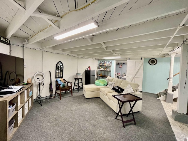 living room featuring concrete block wall and stairs