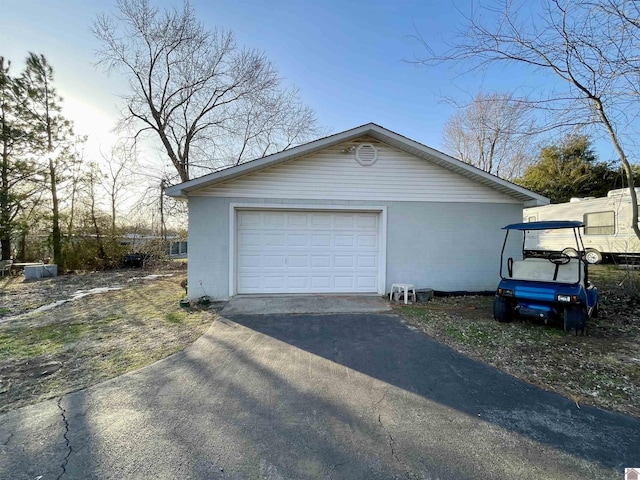 detached garage with aphalt driveway