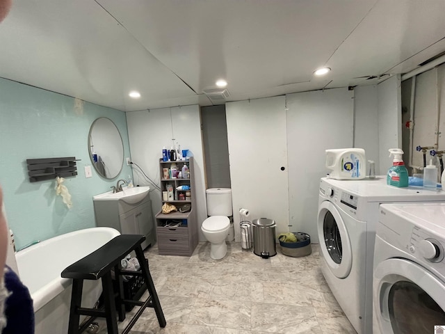 laundry room with recessed lighting, a sink, visible vents, and washer and dryer